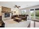 Cozy living room featuring a stone fireplace, plush seating, and natural light at 22302 Quail Run Way, Parker, CO 80138