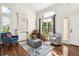 Bright living room with hardwood floors, statement fireplace, and large windows at 22302 Quail Run Way, Parker, CO 80138