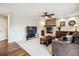 Spacious living room with stone fireplace, ceiling fan, and comfortable furniture at 22302 Quail Run Way, Parker, CO 80138