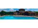 A sparkling community pool with ample lounge chairs, adjacent to a clubhouse with architectural details at 22302 Quail Run Way, Parker, CO 80138