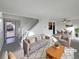 Virtually staged living room with gray sofa and dining area at 4974 E 124Th Way, Thornton, CO 80241