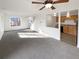 Open living room and kitchen with neutral carpeting at 4974 E 124Th Way, Thornton, CO 80241