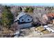 An aerial view of a two-story home with solar panels and a three-car garage at 6148 W Pacific Cir, Lakewood, CO 80227