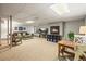 Finished basement Gathering room with fireplace, TV, and comfortable seating at 6148 W Pacific Cir, Lakewood, CO 80227