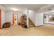 Finished basement with stairs, storage, and a hallway leading to other rooms at 6148 W Pacific Cir, Lakewood, CO 80227