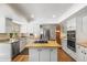 Modern kitchen with island, stainless steel appliances, and hardwood floors at 6148 W Pacific Cir, Lakewood, CO 80227