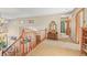 Upstairs hallway with wood railing and carpet at 6148 W Pacific Cir, Lakewood, CO 80227