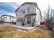 An exterior view of the home shows a spacious patio and large windows for natural light and outdoor enjoyment at 6313 E 130Th Ave, Thornton, CO 80602