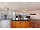 Open kitchen with a granite-topped island and view of the fireplace in the living area at 6313 E 130Th Ave, Thornton, CO 80602