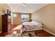 Comfortable main bedroom featuring wood floors and natural light from a large window at 6313 E 130Th Ave, Thornton, CO 80602