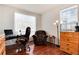 Bright home office space featuring wood floors, a comfortable chair, and plenty of natural light at 6313 E 130Th Ave, Thornton, CO 80602