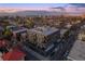 Stunning aerial view of a modern apartment building with private balconies, showcasing the city skyline at sunset at 1300 N Ogden St # 304, Denver, CO 80218