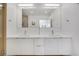 Bathroom featuring double sink vanity, a large mirror, and bright lighting at 1300 N Ogden St # 304, Denver, CO 80218