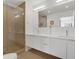 Bathroom featuring a modern vanity, spacious shower, and bright lighting at 1300 N Ogden St # 304, Denver, CO 80218