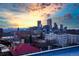 Sweeping city views showcasing Denver's skyline and the Rocky Mountains in the distance at sunset at 1300 N Ogden St # 304, Denver, CO 80218