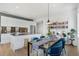 Bright dining area with modern table, comfortable seating and adjacent island with updated appliances at 1300 N Ogden St # 304, Denver, CO 80218