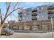 Modern multi-story condo building with brick facade, balconies, and street parking at 1300 N Ogden St # 304, Denver, CO 80218