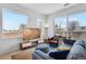 Cozy living room with large windows offering views of the surrounding neighborhood at 1300 N Ogden St # 304, Denver, CO 80218