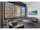 Modern lounge area with comfortable seating, exposed brick wall, and large windows at 1300 N Ogden St # 304, Denver, CO 80218