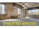 Wide open floor plan with brick accent wall, concrete floor, and large industrial windows at 1300 N Ogden St # 304, Denver, CO 80218
