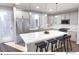 Modern kitchen with white cabinets, stainless steel appliances and a center island with stool seating at 1593 W 166Th Ave, Broomfield, CO 80023