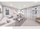 Bright living area with a modern L-shaped sofa, natural light, and neutral tones at 1593 W 166Th Ave, Broomfield, CO 80023