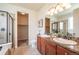 Bright bathroom featuring double sinks, granite countertops, a walk-in shower, and a walk-in closet at 1358 14Th Ave, Longmont, CO 80501