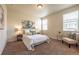 Cozy bedroom with plush carpet, a queen bed, and soft, natural light from dual windows at 1358 14Th Ave, Longmont, CO 80501