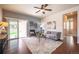 Bright living room featuring hardwood floors, a ceiling fan, and a sliding door to the backyard at 1358 14Th Ave, Longmont, CO 80501