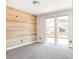 A serene bedroom featuring a striking wood accent wall and large windows at 6021 N Boston Ct, Denver, CO 80238