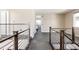 A bright hallway with a modern railing, showcasing a clean and open design at 6021 N Boston Ct, Denver, CO 80238