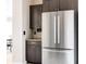 Kitchen showcases stainless steel refrigerator and custom cabinetry with modern fixtures and finishes at 6021 N Boston Ct, Denver, CO 80238