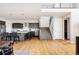 Open-concept kitchen with a large island, stainless steel appliances, and staircase to the second level at 6021 N Boston Ct, Denver, CO 80238