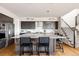 Open-concept kitchen featuring a large island with seating and modern pendant lighting at 6021 N Boston Ct, Denver, CO 80238
