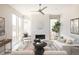 Bright living room featuring a modern fireplace, stylish decor, and abundant natural light at 6021 N Boston Ct, Denver, CO 80238