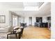 Open floor plan integrating living, dining, and kitchen areas with hardwood flooring and modern decor at 6021 N Boston Ct, Denver, CO 80238