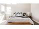 Main bedroom featuring a beautifully styled bed, ample natural light, and soothing decor at 6021 N Boston Ct, Denver, CO 80238