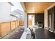 Inviting outdoor patio with a wood ceiling, stone accent wall, and backyard access at 6021 N Boston Ct, Denver, CO 80238