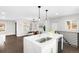 Modern kitchen with quartz countertops, stainless steel appliances, and open design flowing into the dining area at 2839 Ivanhoe St, Denver, CO 80207