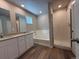 Bathroom featuring double sink vanity, a soaking tub and a glass enclosed shower at 48285 Shetland Dr, Bennett, CO 80102
