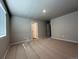 Large bedroom with neutral carpet, good natural light, and an attached closet at 48285 Shetland Dr, Bennett, CO 80102