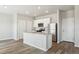 Bright kitchen featuring an island with a sink, stainless steel appliances, and white cabinetry at 48285 Shetland Dr, Bennett, CO 80102