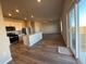 Modern kitchen with stainless steel appliances, a kitchen island, hardwood flooring, and an open floorplan at 48285 Shetland Dr, Bennett, CO 80102