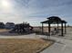 Community playground with modern play equipment, picnic benches and a shaded gazebo at 48285 Shetland Dr, Bennett, CO 80102