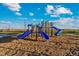 Colorful playground with multiple slides, climbing structures, and ample space for play at 48285 Shetland Dr, Bennett, CO 80102