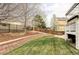 Well-maintained backyard with retaining walls, green grass, and a wooden fence at 6103 S Millbrook Ct, Aurora, CO 80016