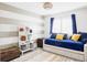 Stylish bedroom featuring a daybed, modern shelving, and a vibrant rug at 6103 S Millbrook Ct, Aurora, CO 80016