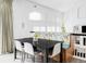 Bright dining area with a modern table, banquette seating, and fireplace views at 6103 S Millbrook Ct, Aurora, CO 80016