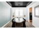 Elegant dining room featuring a glass table, modern chandelier, and stylish decor at 6103 S Millbrook Ct, Aurora, CO 80016