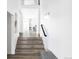 Bright entryway featuring wood floors, a staircase, and an open view of the dining area at 6103 S Millbrook Ct, Aurora, CO 80016